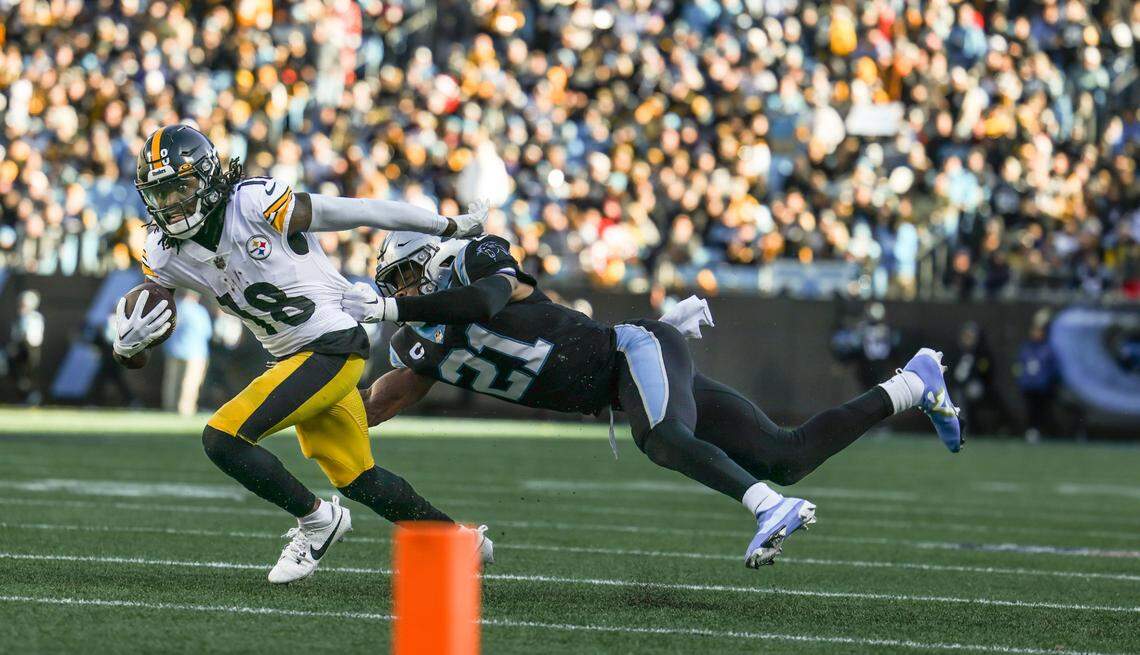 Pittsburgh Steelers wide receiver Diontae Johnson (18), left, escapes a tackle by Carolina Panthers safety Jeremy Chinn (21) at the Bank of America Stadium in Charlotte, N.C., on Sunday, December 18, 2022.
