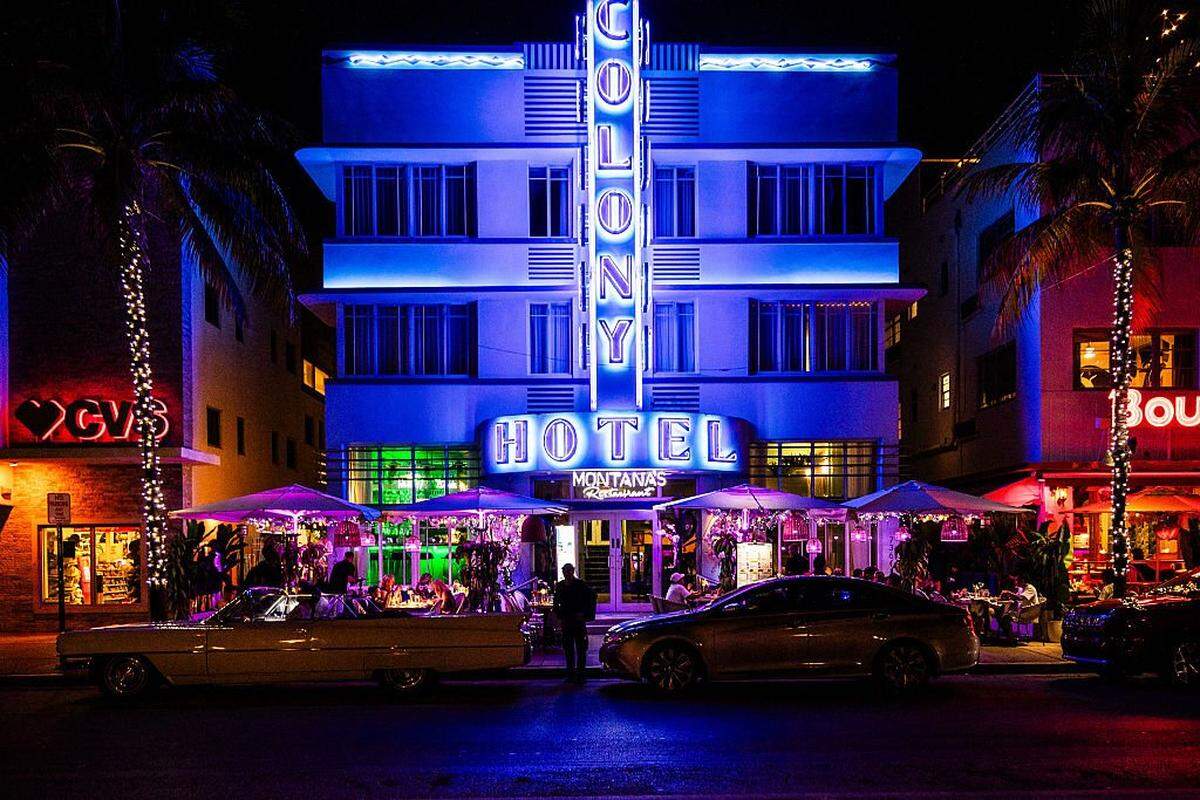 Colony Hotel Art Deco known by Scarface as Tony Montana s night restaurant with lights and neon and many customers under umbrellas on Ocean Drive in Miami Beach in the state of Florida in the United States of America (USA) on August 4, 2025. (Photo by Jc Milhet / Hans Lucas via AFP) (Photo by JC MILHET/Hans Lucas/AFP via Getty Images)          