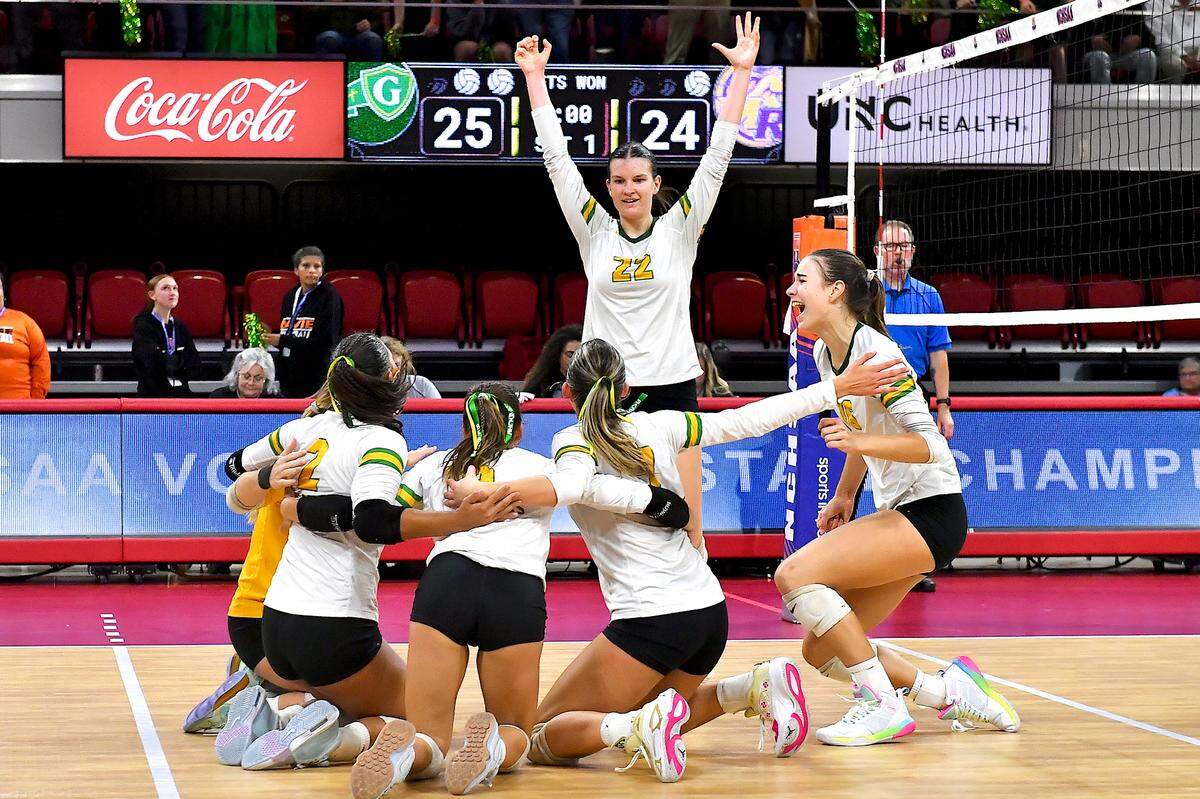 Cardinal Gibbons’ Mary Grace Gonyeau (22) reacts and celebrates with her team after their victory over Marvin Ridge in the NCHSAA 4A Volleyball Championship. The Marvin Ridge Mavericks took on the Cardinal Gibbons Crusaders in the NCHSAA 4A Volleyball Championship match in Raleigh, N.C. on November 2, 2024.