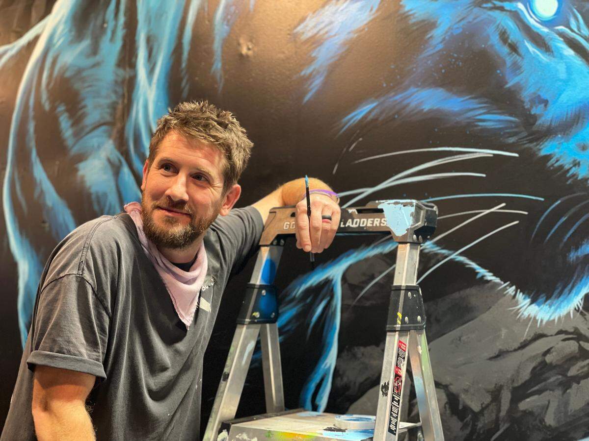 Matt Moore, lifelong North Carolinian and well-known Charlotte muralist, worked on a project with the Carolina Panthers in Bank of America Stadium before the team’s 2024 home opener.