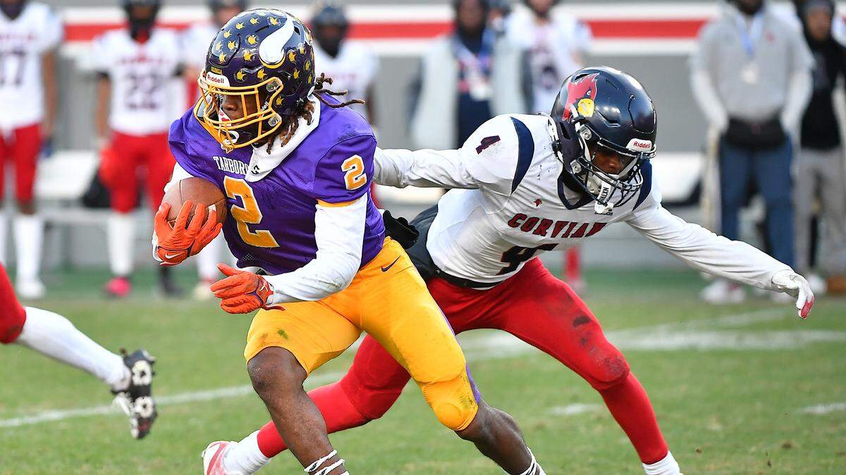Tarboro’s Kamerin McDowell-Moore (2) runs past Corvian’s BJ McAdoo (4) for yardage during the first half. The Corvian Community Cardinals and the Tarboro Vikings met in the NCHSAA 1A football Championship Game in Raleigh, N.C. on December 21, 2024.