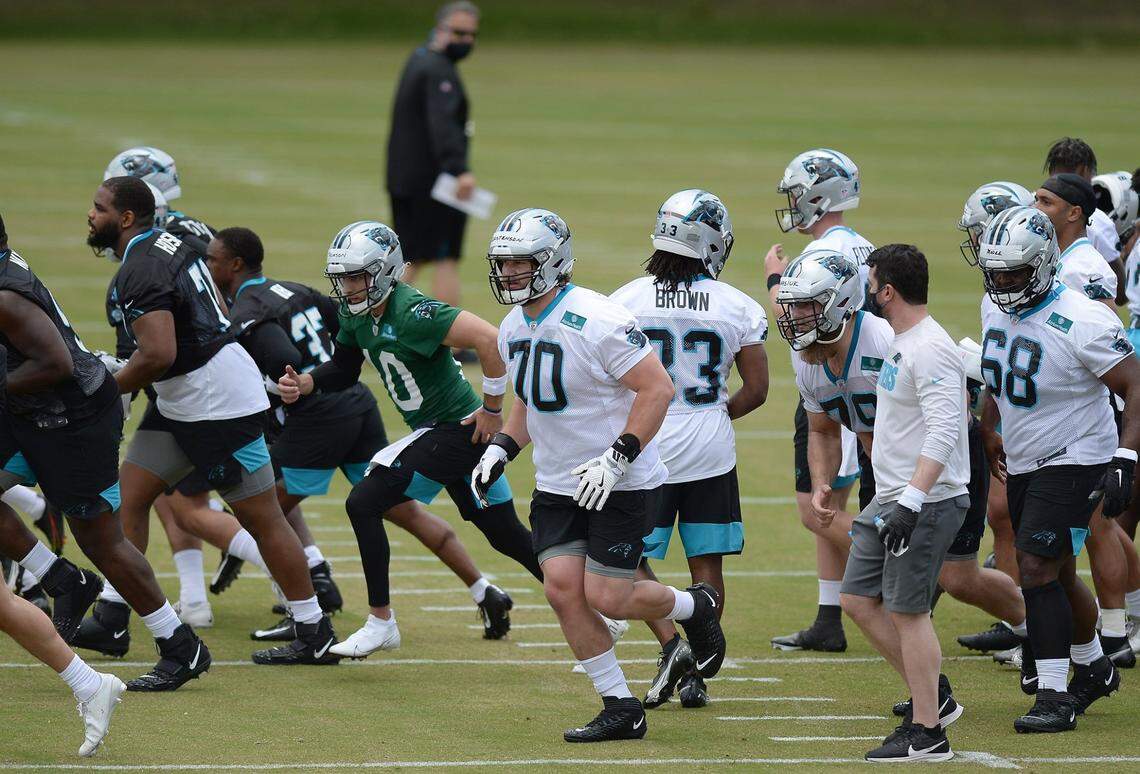 Carolina Panthers rookie tackle Brady Christensen, center, runs across the field with his teammates to begin drills during the team’s 2021 rookie minicamp practice on Friday, May 14, 2021.