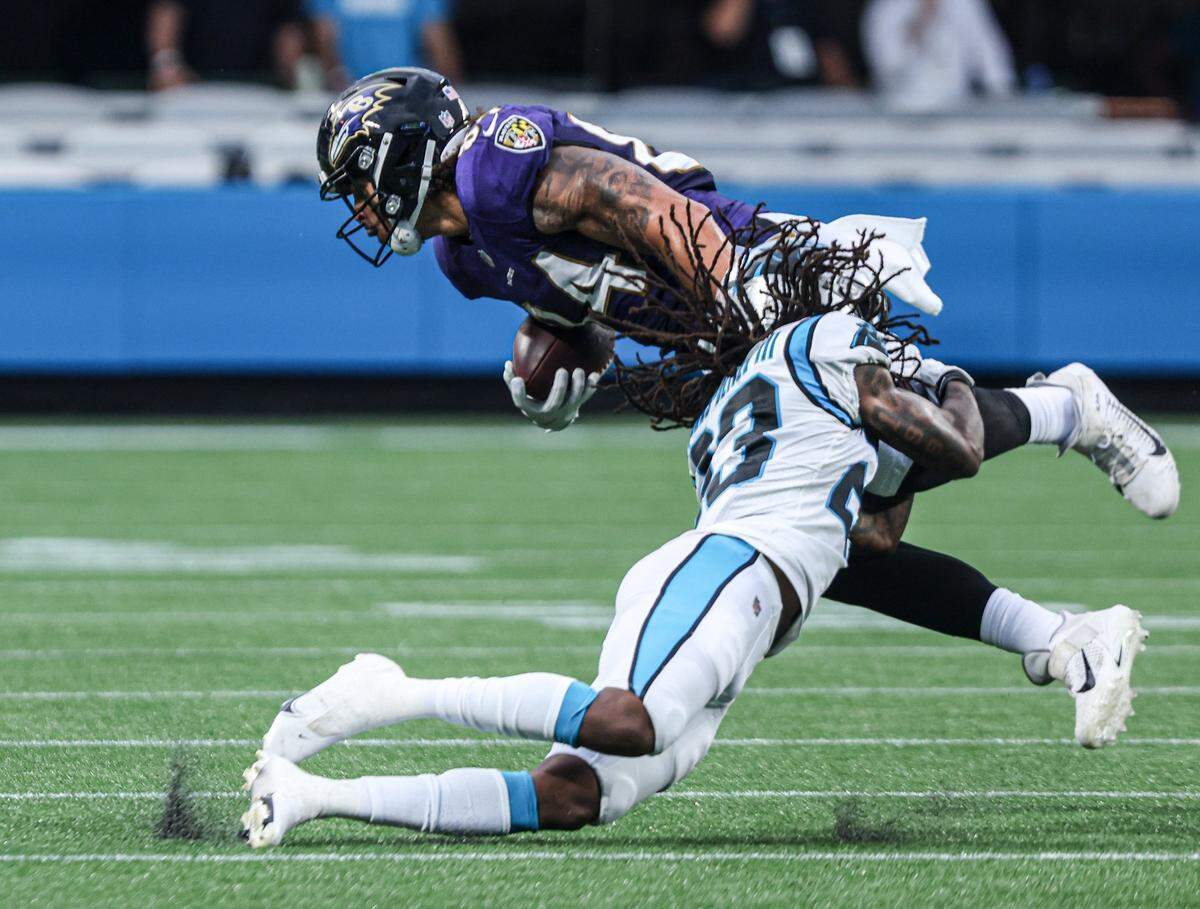 Carolina Panthers Spencer Brown, bottom, tackles Baltimore Ravens Josh Oliver at the Bank of America Stadium in Charlotte, N.C., on Saturday, August 21, 2021.