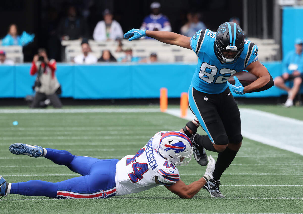 Carolina Panthers' Tommy Tremble carries the ball as Joe Andreessen tries to pull him down during Sunday’s game at Bank of America Stadium.