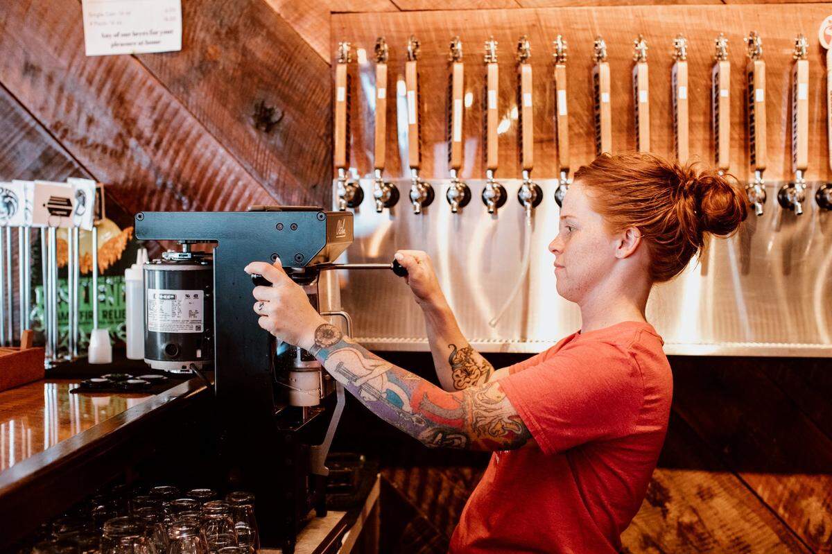 Cavendish taproom manager Preslie Davis fills a can of beer at Cavendish Brewing Company’s Gastonia taproom.
