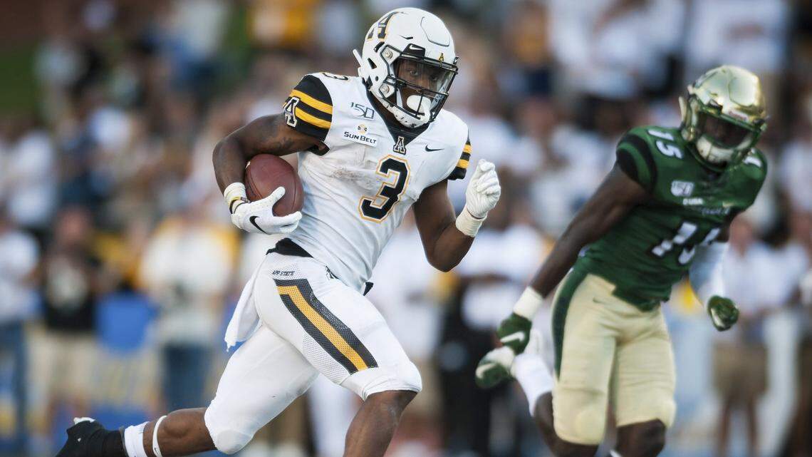 Appalachian State running back Darrynton Evans (3) rushes past Charlotte defensive back Marquavis Gibbs for a touchdown in the fourth quarter of the Mountaineers’ victory Saturday.