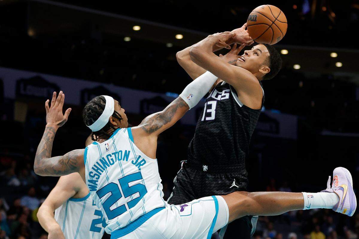 Charlotte Hornets forward P.J. Washington (25) blocks Sacramento Kings forward Keegan Murray (13) at the basket during a game at Spectrum Center in Charlotte, N.C., Monday, Oct. 31, 2022.