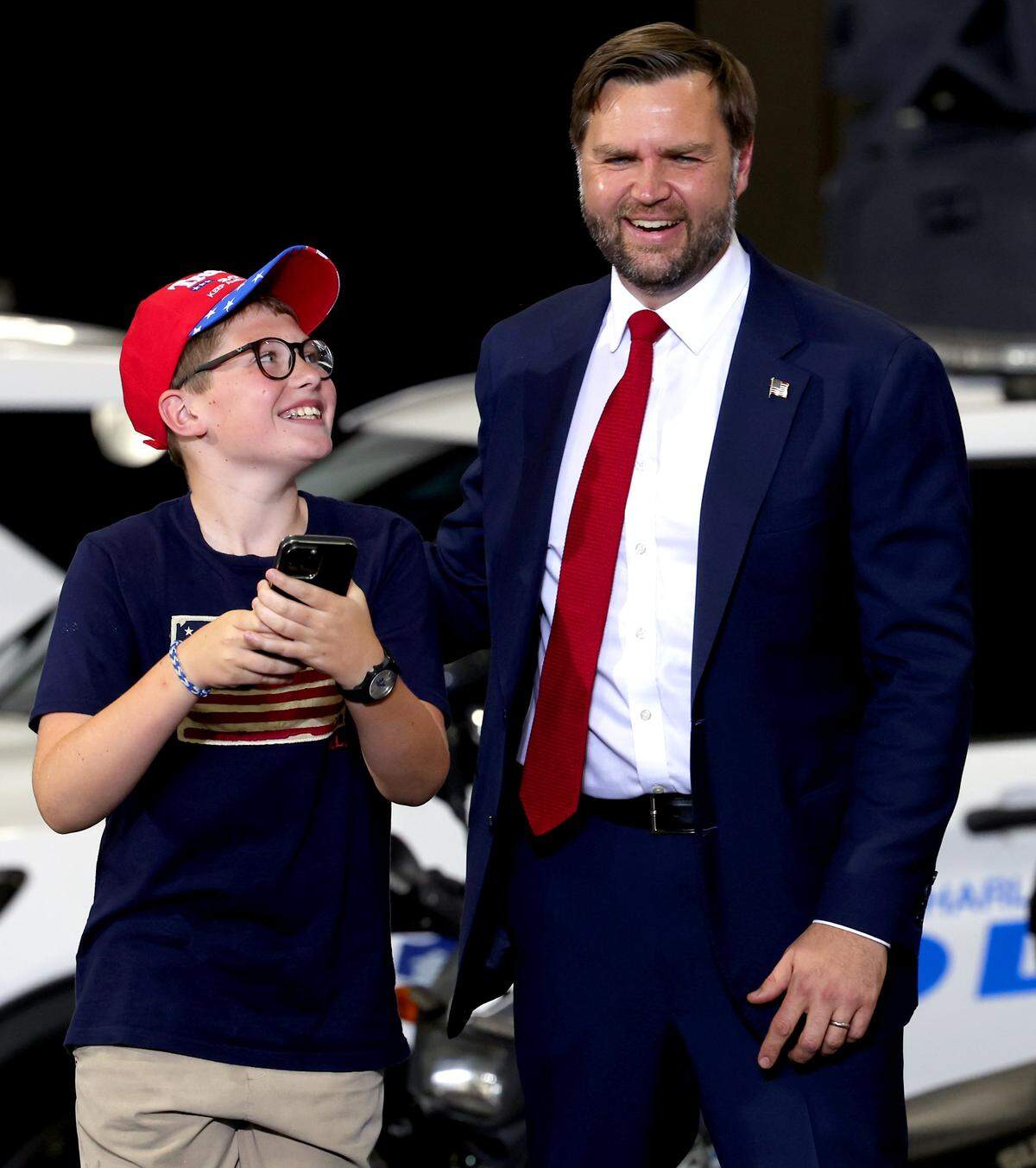 Vice President JD Vance, right, smiles at the audience as 12-year-old Henry James, left, of Huntersville, NC smiles after taking a selfie with the vice president on Wednesday, September 24, 2025. Vance gave a speech where he spoke about the death of Iryna Zarutska, Charlie Kirk and the administration’s tax cuts for working families and commitment to empowering state and law enforcement during a speech at the DKAP Hanger at Concord Padgett Regional Airport in Concord, NC.