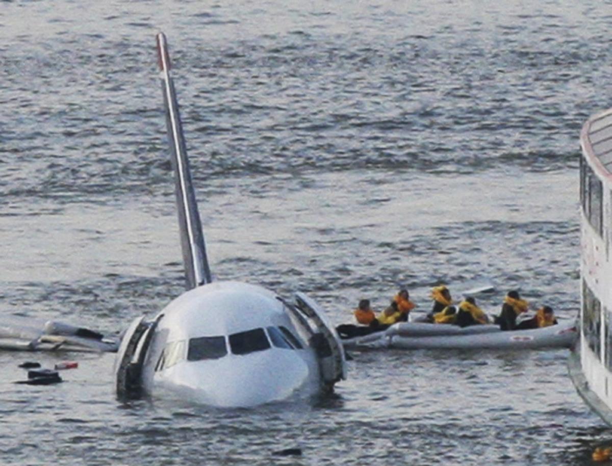 In this 2009 file photo of the “Miracle on the Hudson” plane, passengers in an inflatable raft move away from the US Airways plane in the Hudson River in New York.
