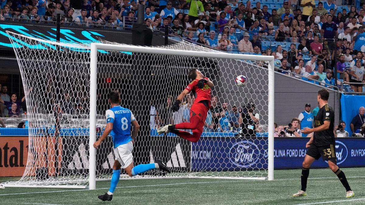 Charlotte FC midfielder Ashley Westwood (8) scores a goal past Los Angeles FC goalkeeper John McCarthy (77) in the first half at Bank of America Stadium.