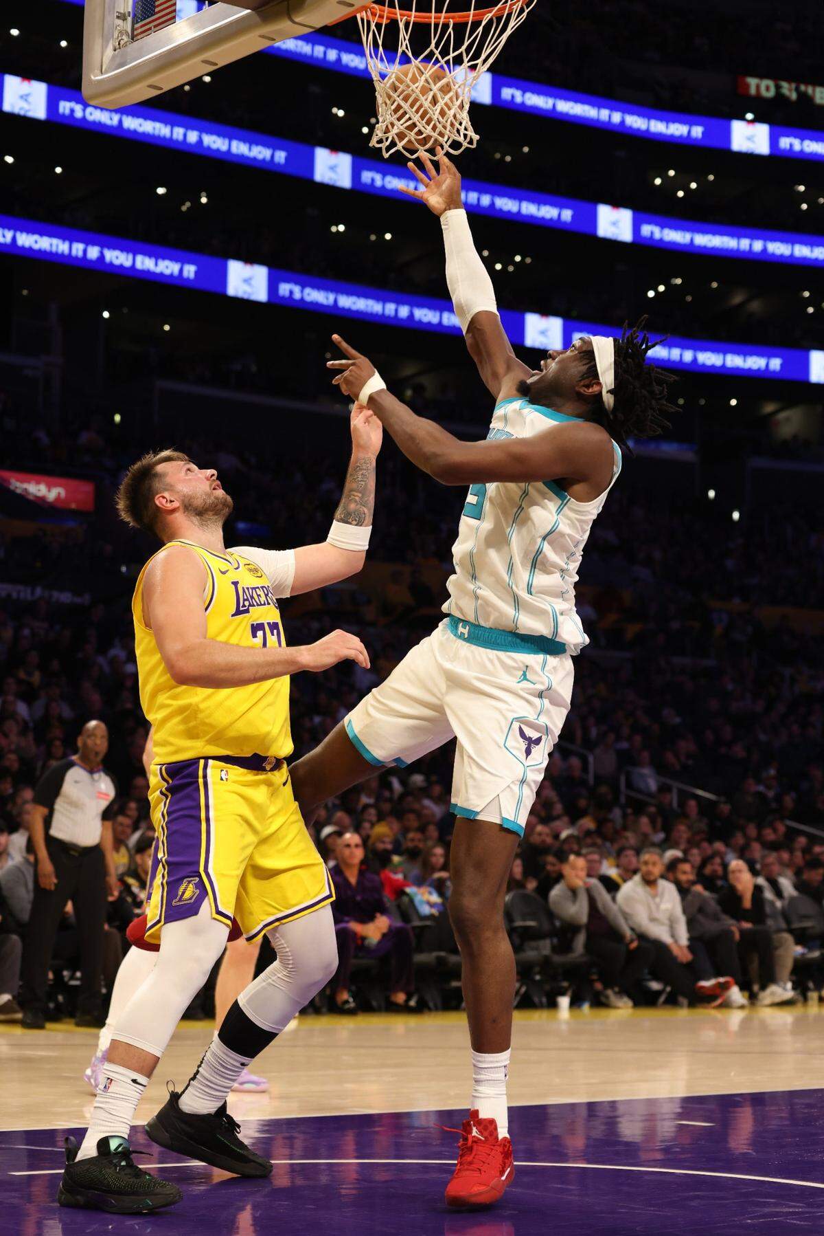Feb 19, 2025; Los Angeles, California, USA; Charlotte Hornets center Mark Williams (5) shoots against Los Angeles Lakers guard Luka Doncic (77) during the third quarter at Crypto.com Arena. Mandatory Credit: Jason Parkhurst-Imagn Images