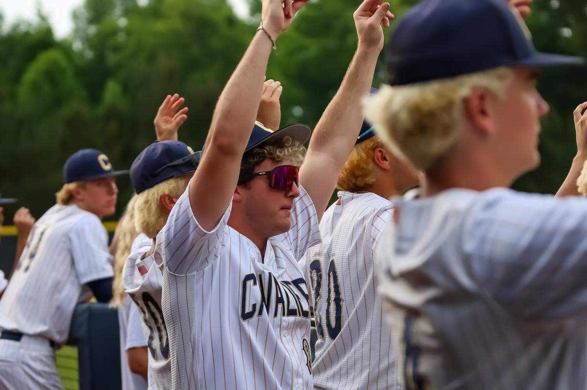 Cuthbertson players cheer from the dugout as their team takes the lead against West Forsyth at the NCHSAA 4A playoffs at Cuthbertson high school in Waxhaw, NC on May 16th, 2025