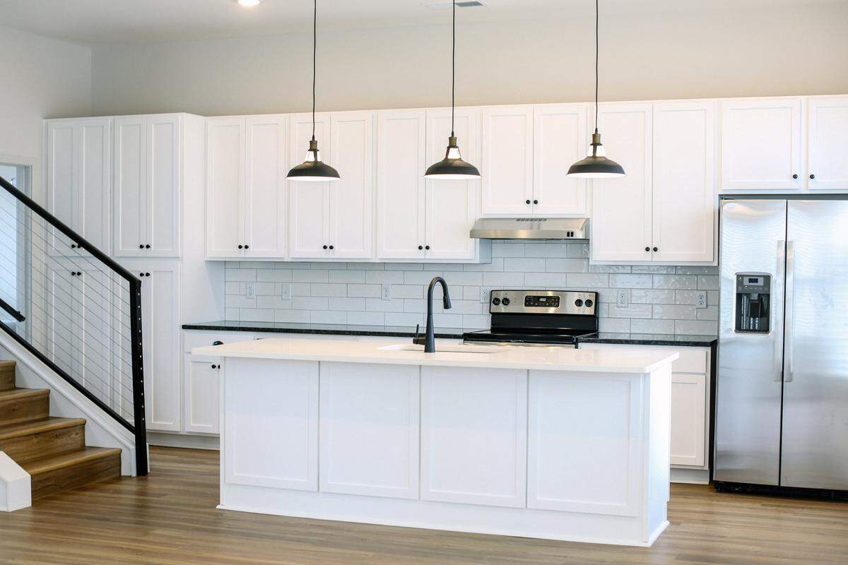 Quartz countertops, matte black fixtures and stainless steel appliances make these townhomes HGTV-worthy.