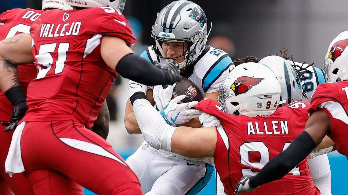Carolina Panthers running back Christian McCaffrey (22) is stopped by Arizona Cardinals defensive end Zach Allen (94) during a game at Bank of America Stadium in Charlotte, N.C., Sunday, Oct. 2, 2022.