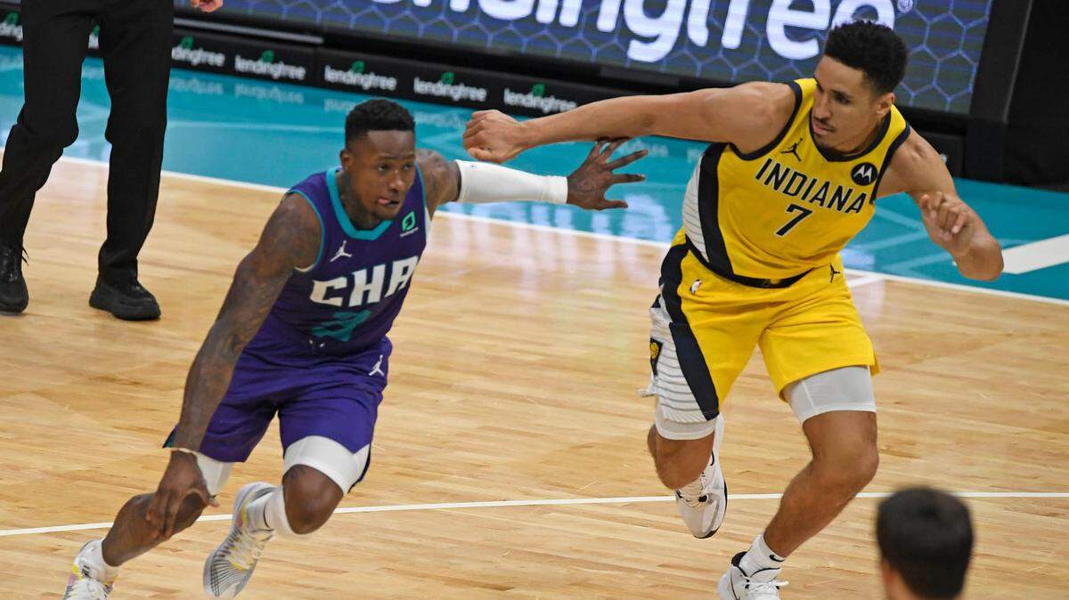 Charlotte Hornets guard Terry Rozier (3) drives past Indiana Pacers guard Malcolm Brogdon (7) during the a Jan. 27th game. The Hornets travel to Indiana Tuesday night in a do-or-die game in the NBA play-in tournament.