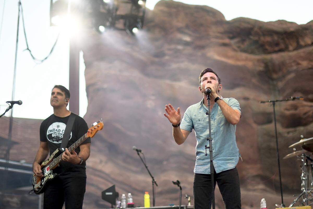 Bob Crawford, left, and Scott Avett of The Avett Brothers perform at Red Rocks Amphitheatre in 2018 in Colorado. Crawford worked on his book for a year between 2024 and 2025 while touring with the band, but always put away the work when it was time for sound checks ahead of their concerts..