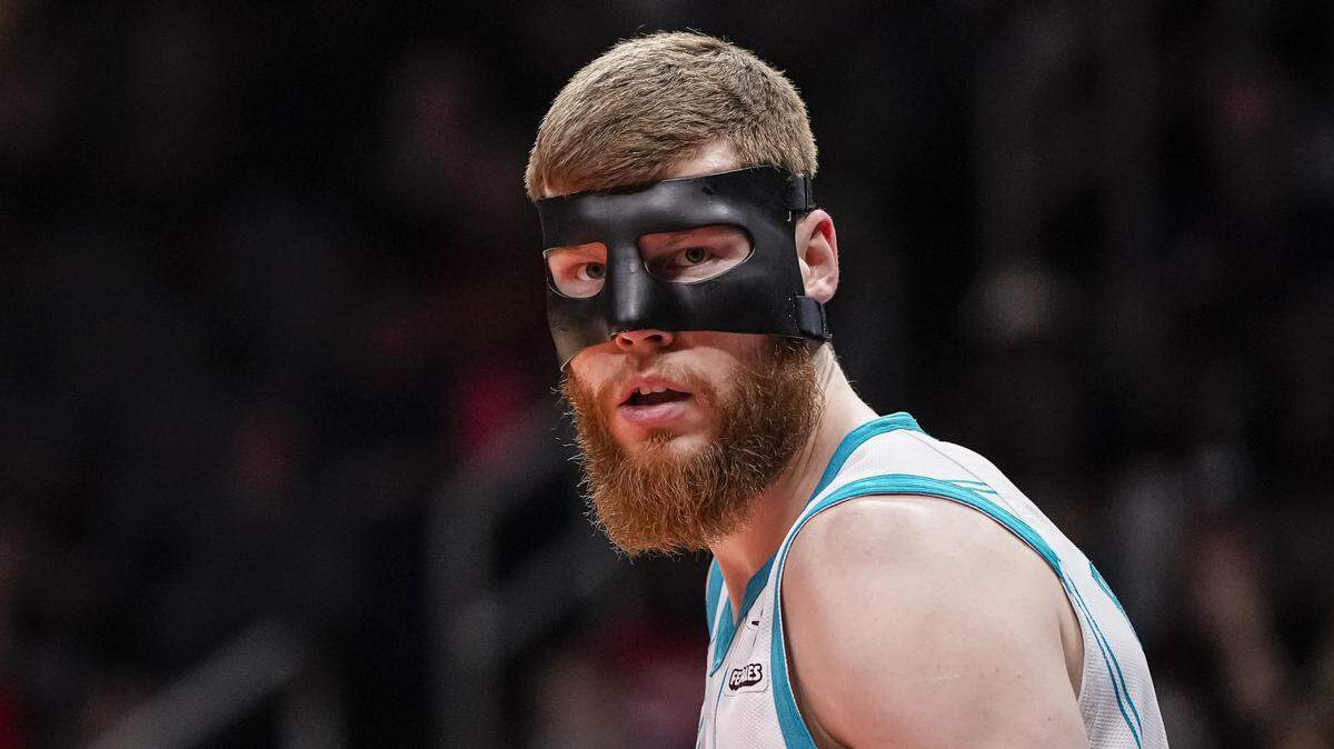 Davis Bertans (9) shown on the court wearing a mask against the Atlanta Hawks during the first half at State Farm Arena.