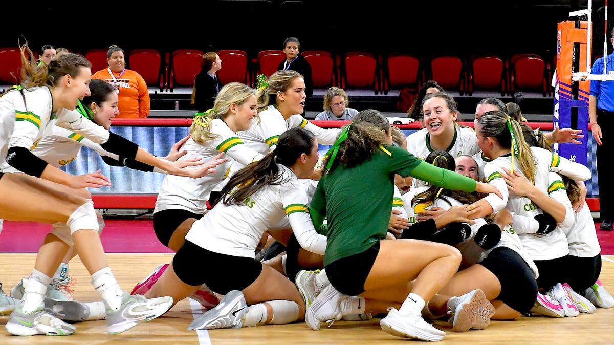 The Cardinal Gibbons Crusaders rush the court after their victory over the Marvin Ridge Mavericks in the NCHSAA 4A Volleyball Championship game. The Marvin Ridge Mavericks took on the Cardinal Gibbons Crusaders in the NCHSAA 4A Volleyball Championship match in Raleigh, N.C. on November 2, 2024.