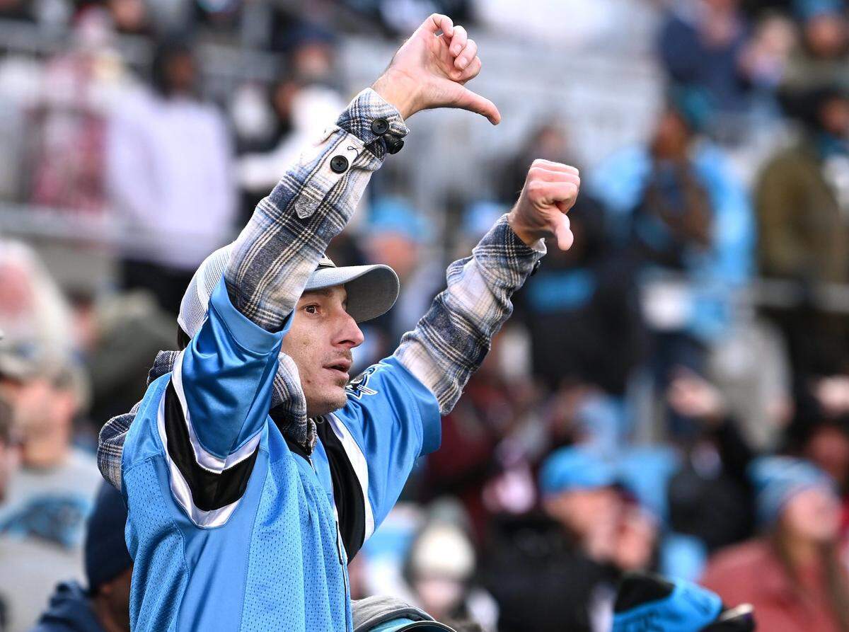 A Carolina Panthers fan gives the thumbs down to the officiating crew during the team’s game against the Tampa Bay Buccaneers at Bank of America Stadium in Charlotte, NC on Sunday, January 7, 2024. The Buccaneers defeated the Panthers 9-0.