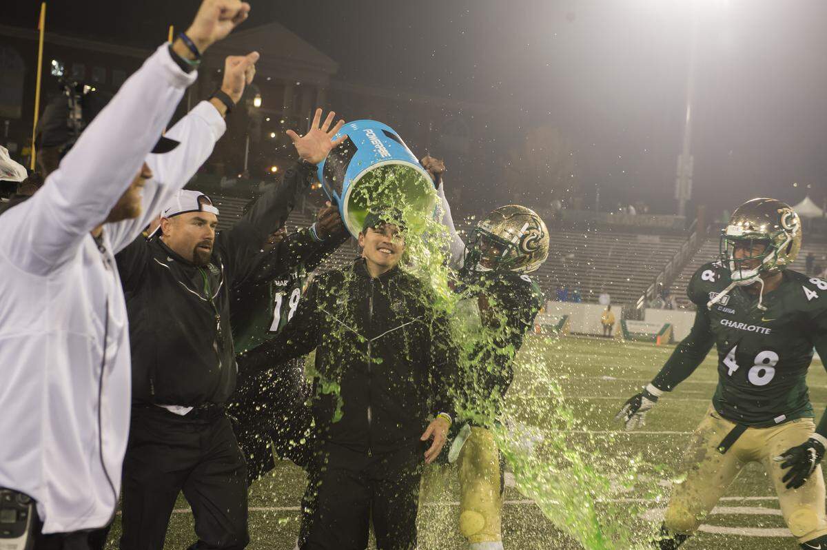 Charlotte 49ers coach Will Healy gets a celebratory bath after his team beat Marshall Nov. 23rd to become bowl-eligible. After this moment, Healy found a player waiting to dump another bucket on him and decided to douse himself with it.