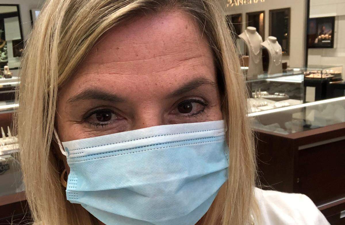 Heidi Abell is sporting a semi-disposable classic blue mask provided to her for work at Windsor Jewelers.