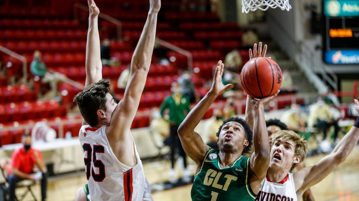 Charlotte guard Jahmir Young (1) shoots over Davidson forward Luka Brajkovic (35) and guard Grant Huffman (5) in the first half of the Battle for the Hornets’ Nest rivalry game at Belk Arena in Davidson. The 49ers won, 63-52, and are 30-17 all time against the Wildcats. For full coverage of Tuesday night’s game, visit CharlotteObserver.com/sports.