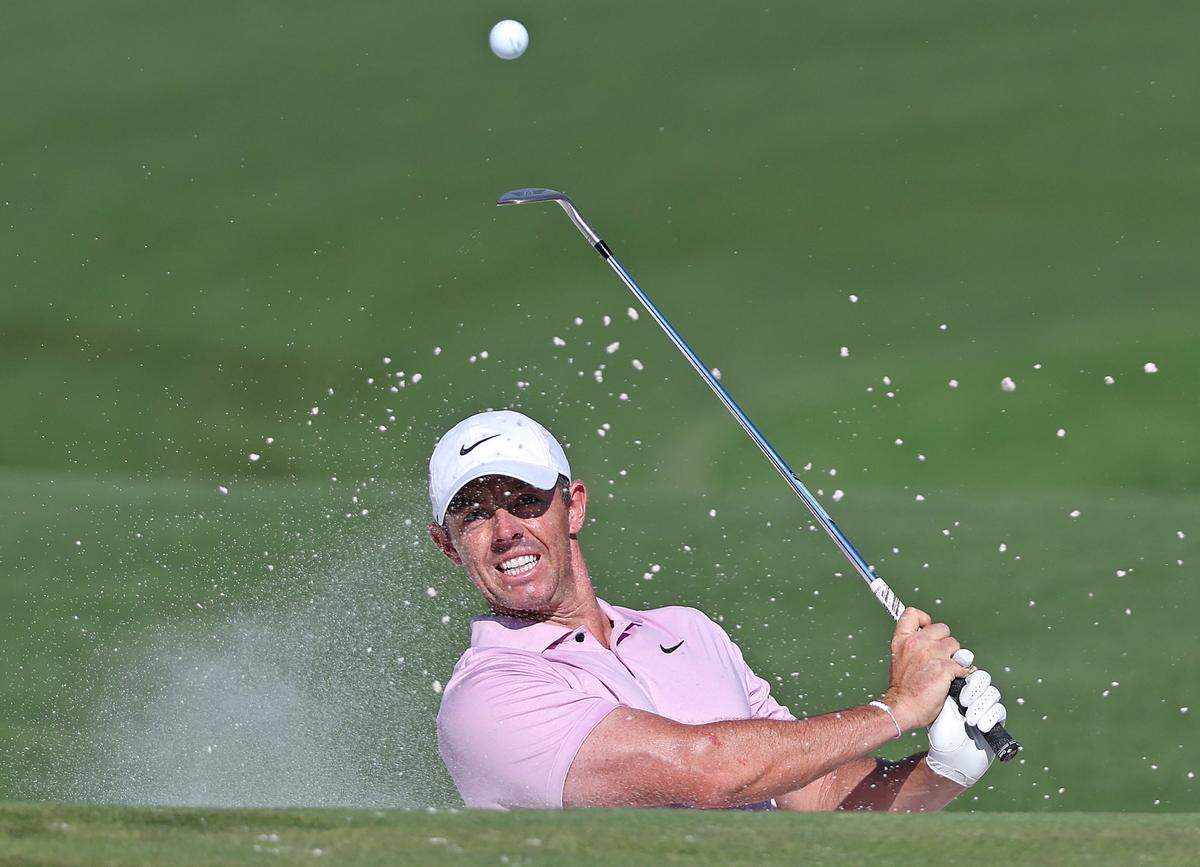 Rory McIlroy watches the flight of his ball from a sand trap at the 15th green during the final round of the Wells Fargo Championship at Quail Hollow Club in Charlotte, NC on Sunday, May 12, 2024. McIlroy sank the chip to eagle the hole. McIlroy won the Wells Fargo Championship at -17.