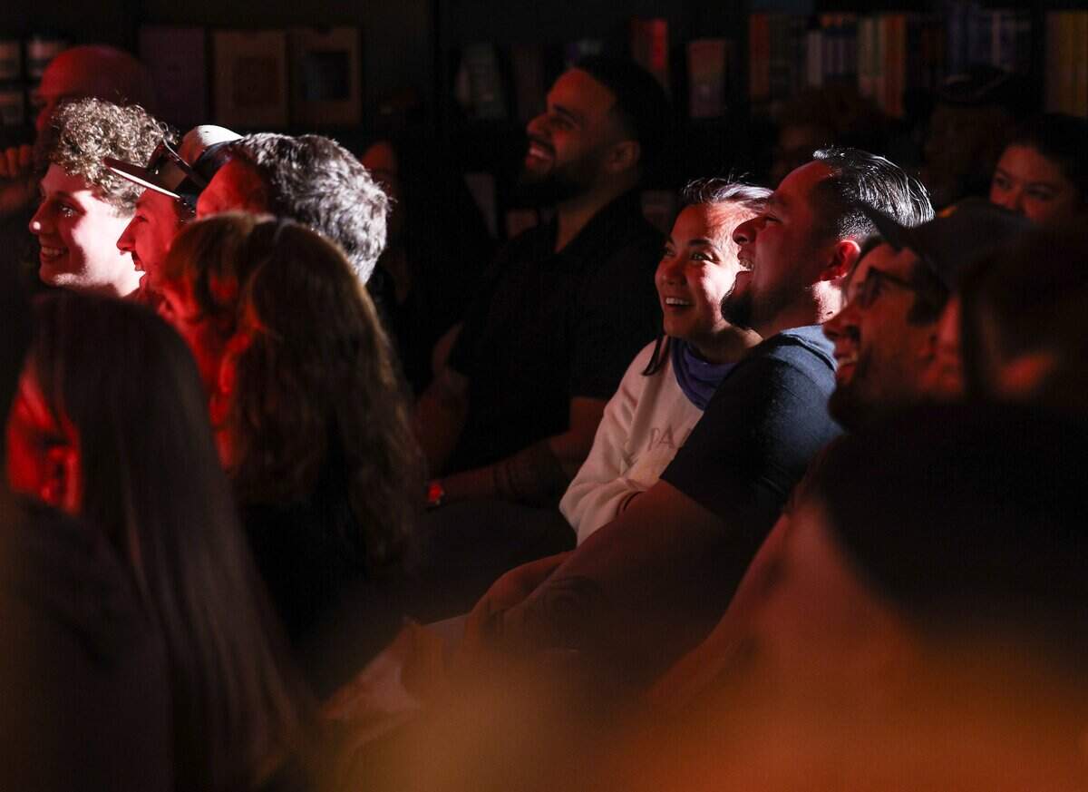Audience members laughs during the Don't Tell Comedy pop-up at That's Novel Books at Camp North End in Charlotte on Saturday, May 23, 2026. The event sold out, packing the tiny bookstore with a little over 60 people.