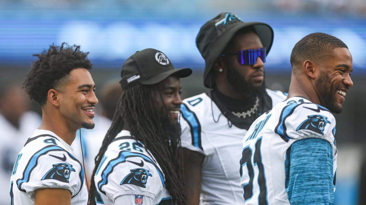 Panthers players Bryce Young, left, Dante Jackson, Brian Burns and Jeremy Chinn, right, share a laugh on the sideline during the pre-season game against the Jets at Bank of America Stadium on Saturday, August 12, 2023 in Charlotte, NC.