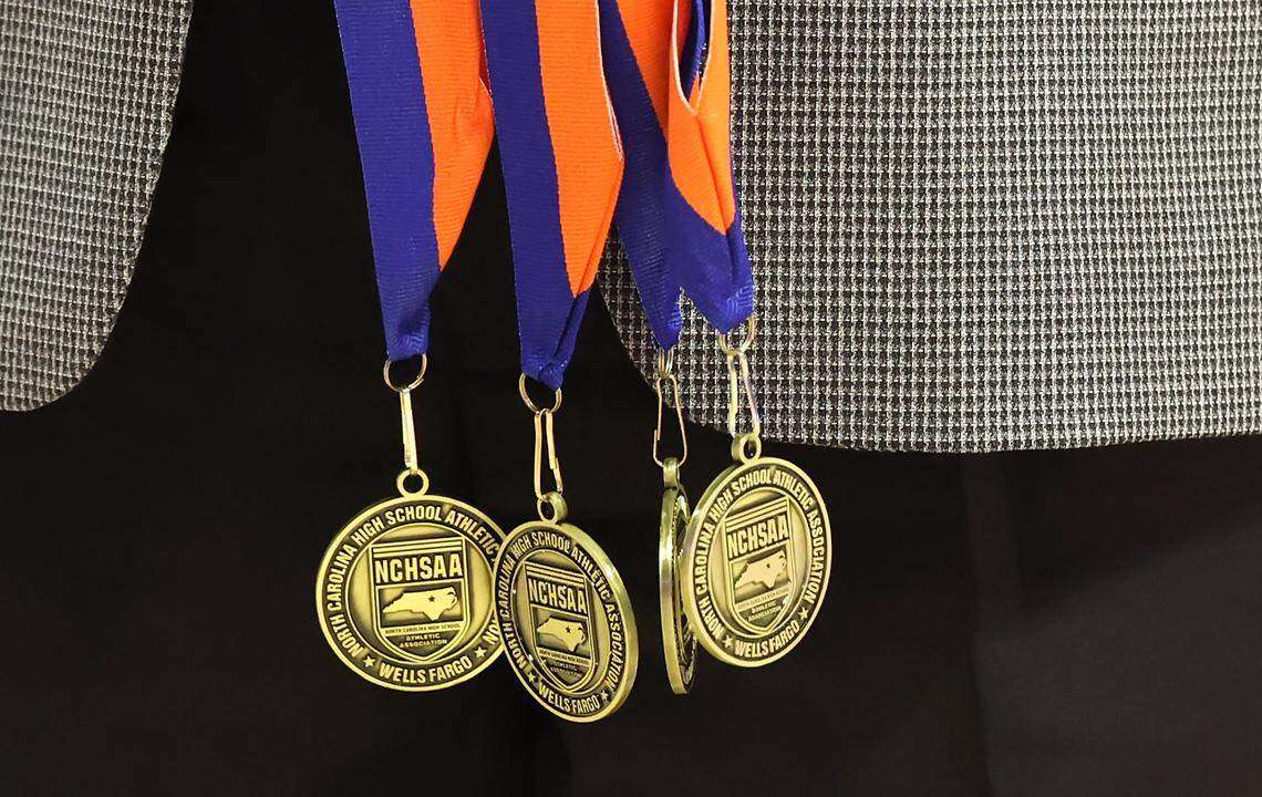 A presenter holds the medals to be presented to the North Meck girls basketball team following their 65-38 win over Southern Durham in the NCHSAA 7A girls championship game on Saturday, March 14, 2026 at Lawrence Joel Veterans Memorial Coliseum in Winston-Salem, NC.