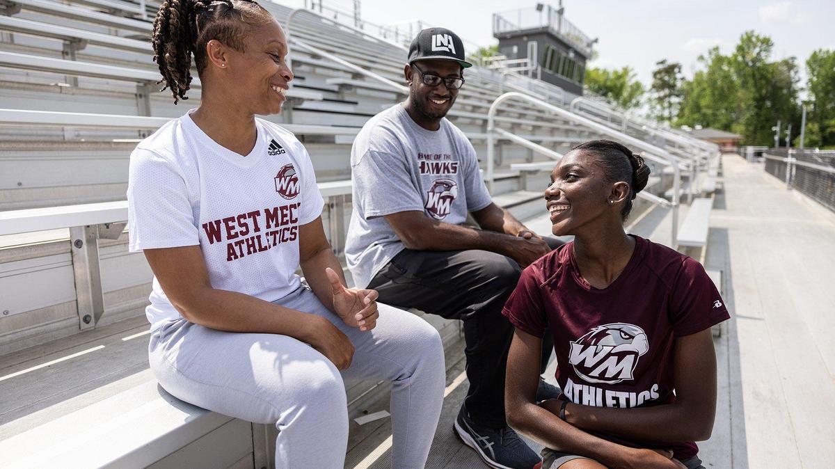 West Mecklenburg track star Sanu Jallow, right, poses for a portrait with her parents, Janelle Johnson-Lockhart and Daszmar Lockhart in Charlotte, N.C., on Tuesday, May 3, 2022.