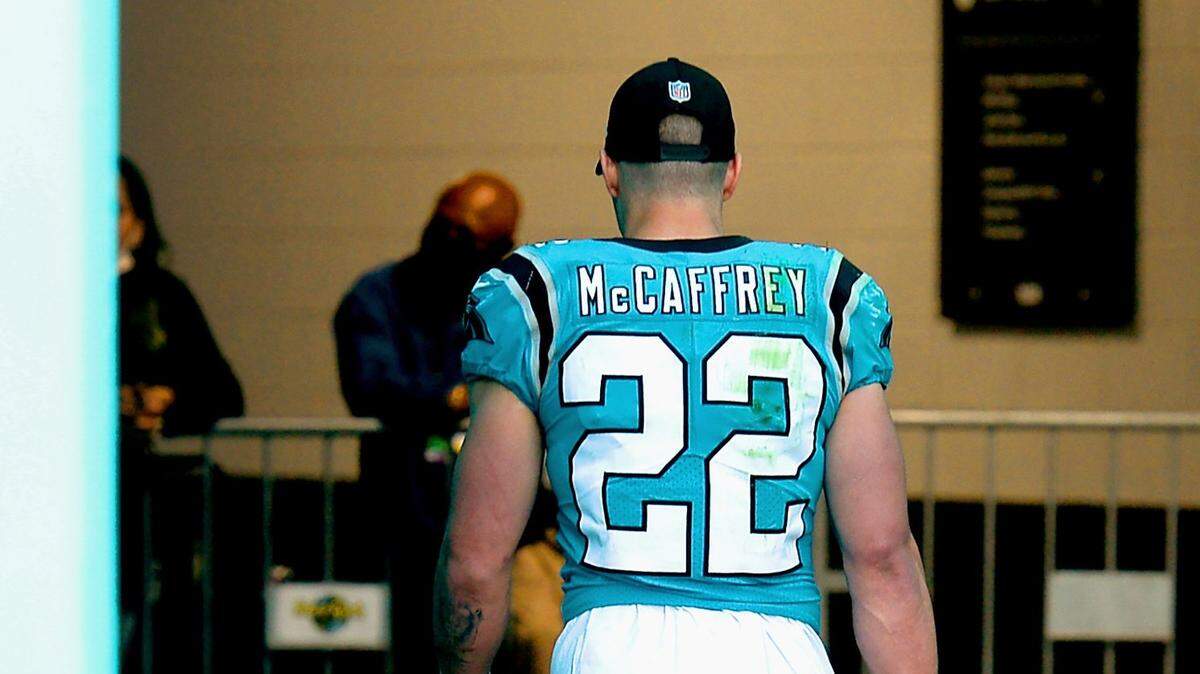 Carolina Panthers running back Christian McCaffrey walks to the team’s locker room following a 33-10 loss to the Miami Dolphins at Hard Rock Stadium in Miami Gardens, Fla. on Sunday, November 28, 2021. McCaffrey missed more than half the game after re-injuring his ankle.