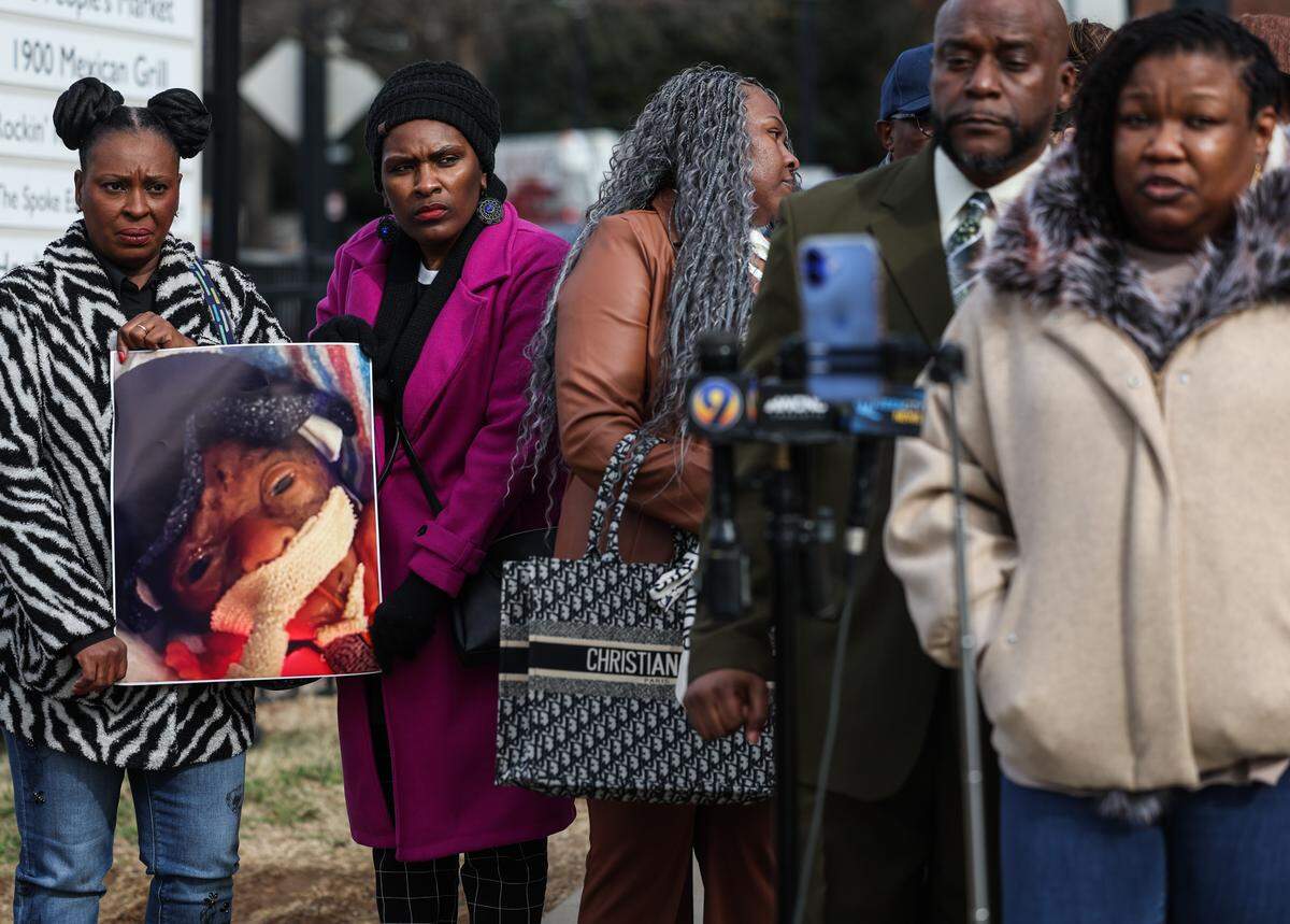 An enlarged photo of Legacy Gray Hunter is held as her mother, Lachunda, speaks at a press conference about her lawsuit against Novant Health on Thursday.