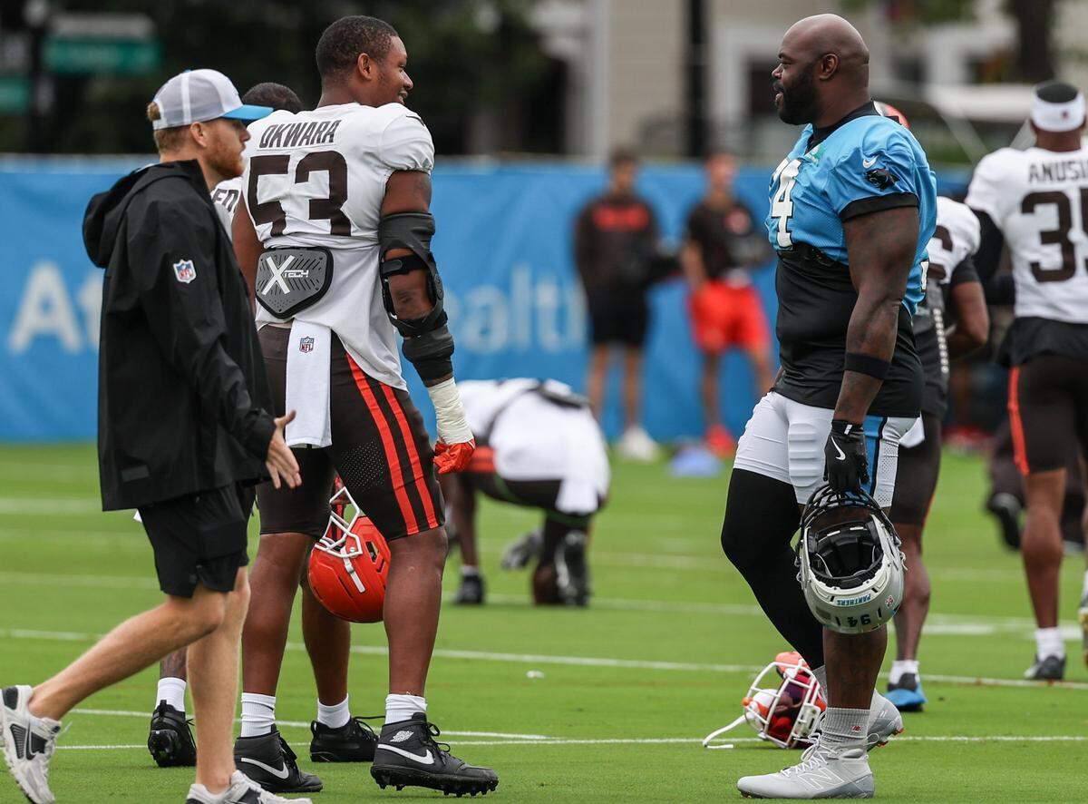 Panthers defensive end A’Shawn Robinson, right, talks to Browns defensive end Julian Okwara before joint practice at training camp in Charlotte, NC on Wednesday, August 6, 2025.