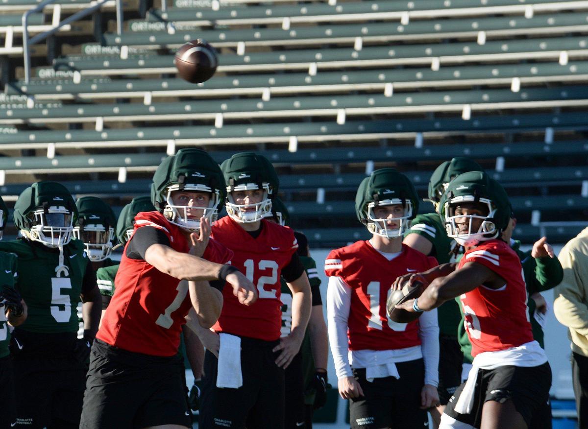 Charlotte 49ers quarterbacks Zach Wilcke (1), Grayson Loftis (12), Tanner Bushee (16) and Conner Harrell (15) during spring workouts.