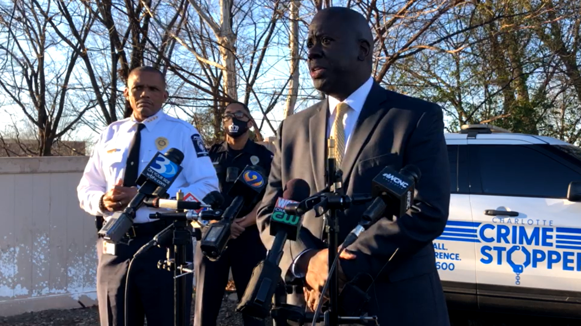 In this screen capture from police video, former Charlotte Mecklenburg Schools Superintendent Earnest Winston, center, and Charlotte-Mecklenburg police Chief Johnny Jennings, left, speak to reporters near West Charlotte High School after gunshots were reported on campus on Monday Dec. 13, 2021.