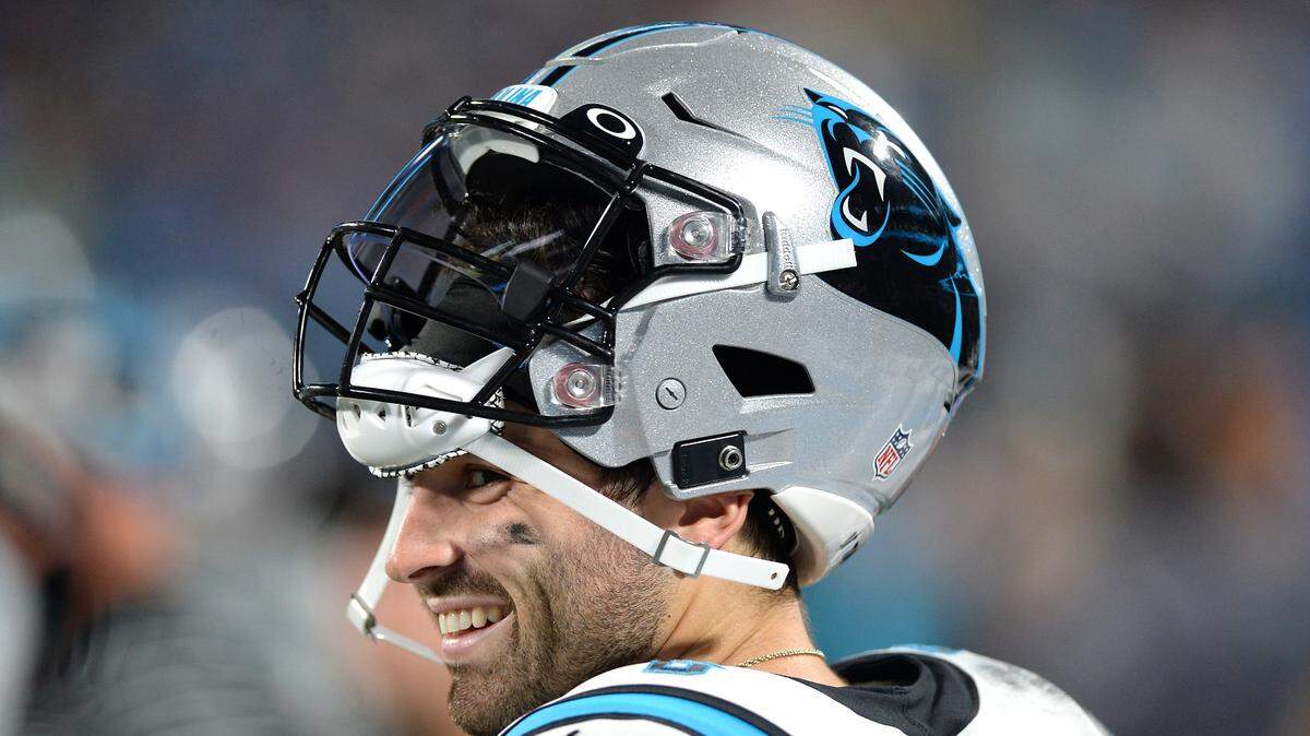 Carolina Panthers quarterback Baker Mayfield smiles as he walks along the team’s sideline during action against the Buffalo Bills at Bank of America Stadium in Charlotte, NC on Friday, August 26, 2022.