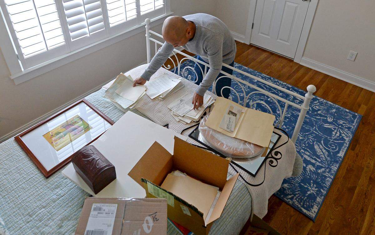 Théoden Janes looks through his adoption records for the first time in more than six years.