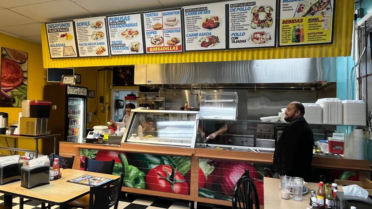 Customer Jose Basada waits on his order at El Sazon Latino in West Charlotte.