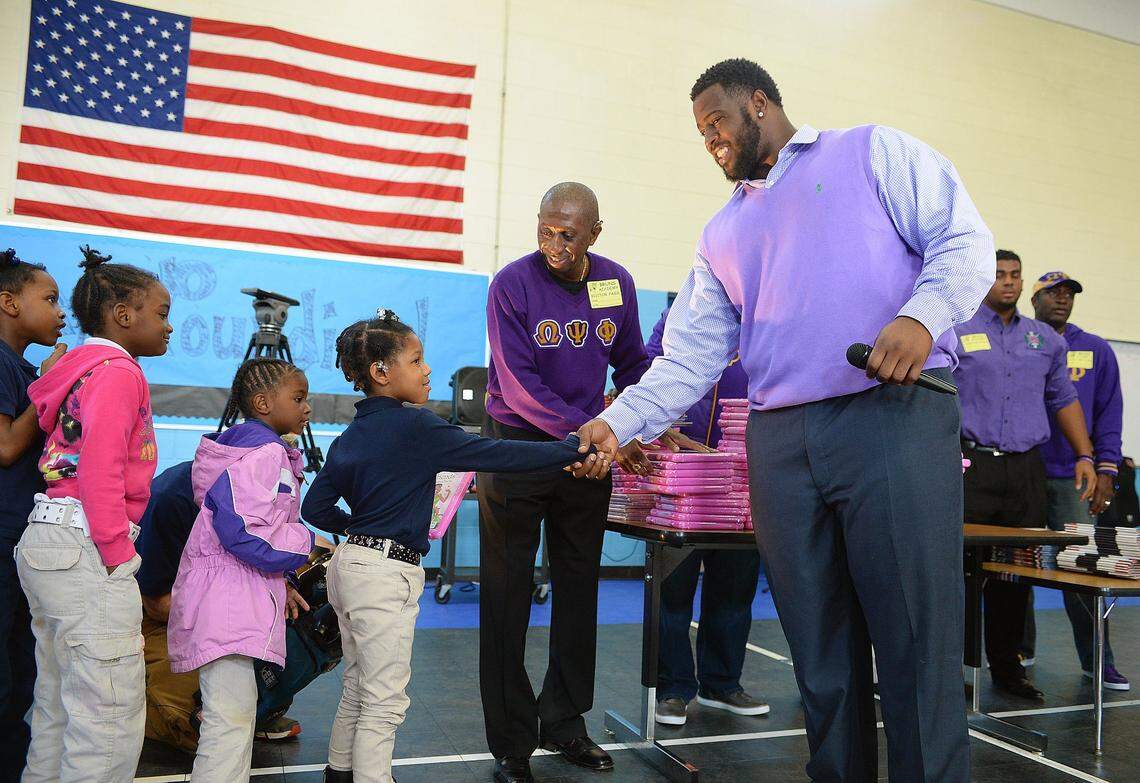 Carolina Panther Kawann Short greets kids while promoting youth literacy at Bruns Avenue Elementary in Charlotte in November 2015.