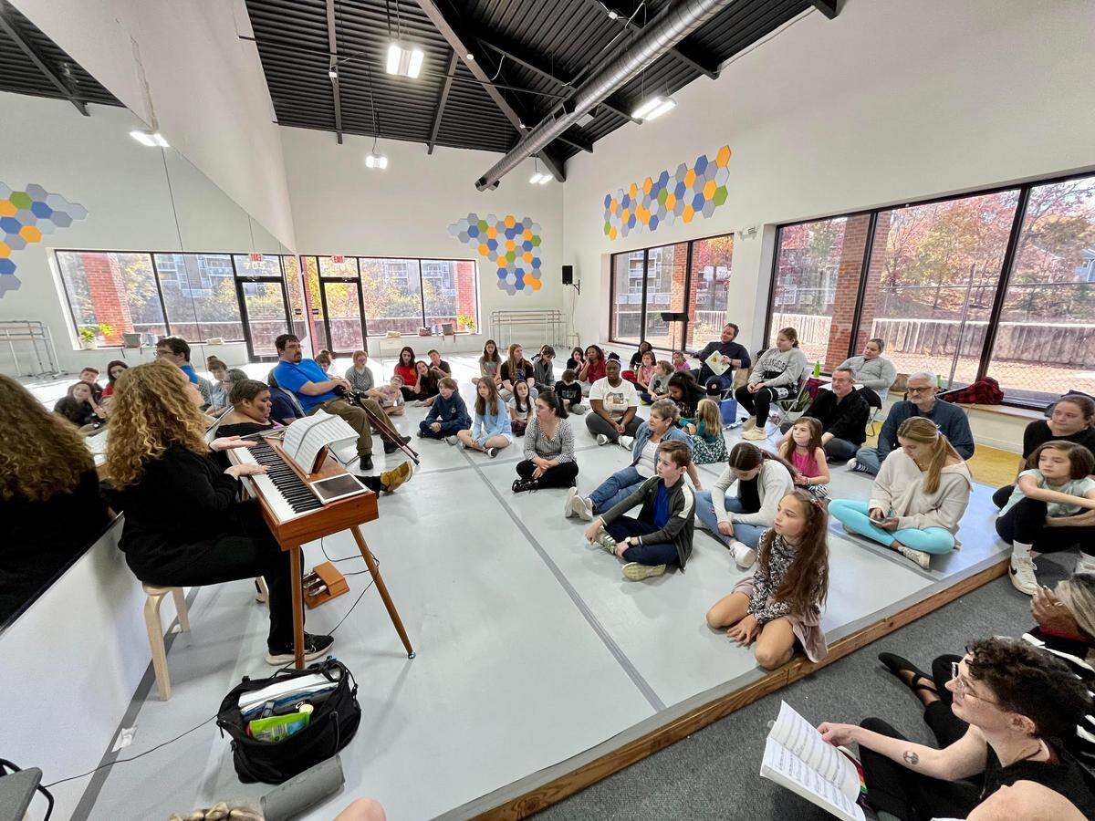 In this 2023 file photo, The Lotus Project founder Susan Cherin is at the piano leading “Godspell” cast members during a rehearsal. She co-founded the company with a focus on diversity, equity, inclusivity and belonging in all of their productions.