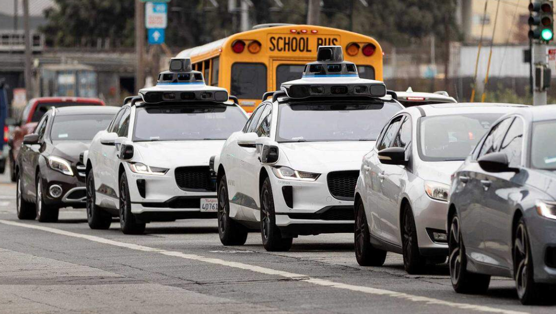 White Waymo autonomous vehicles in San Francisco. The company said Wednesday it is expanding to Charlotte.