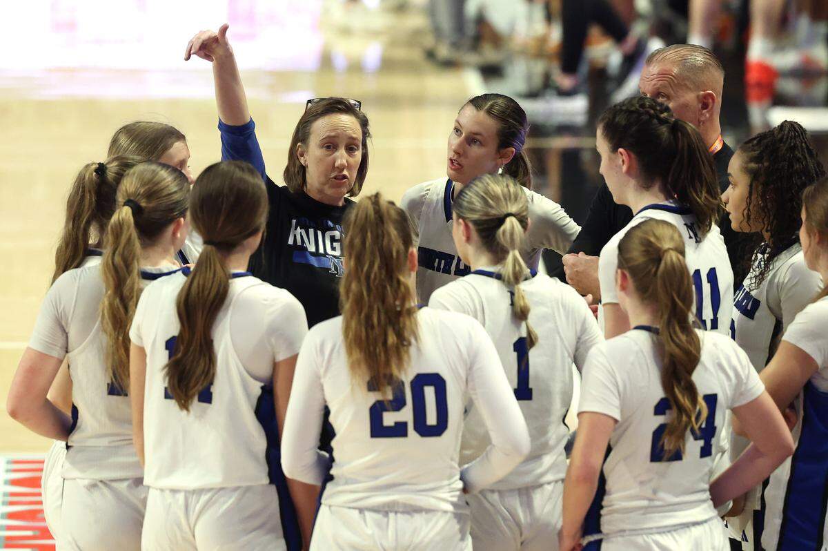 North Lincoln girls’ basketball coach Kristen Karr, center, speaks to her team during a timeout in action against SE Alamance in the 5A girls’ championship game on Saturday at Lawrence Joel Veterans Memorial Coliseum in Winston-Salem. North Lincoln defeated SE Alamance 59-56.