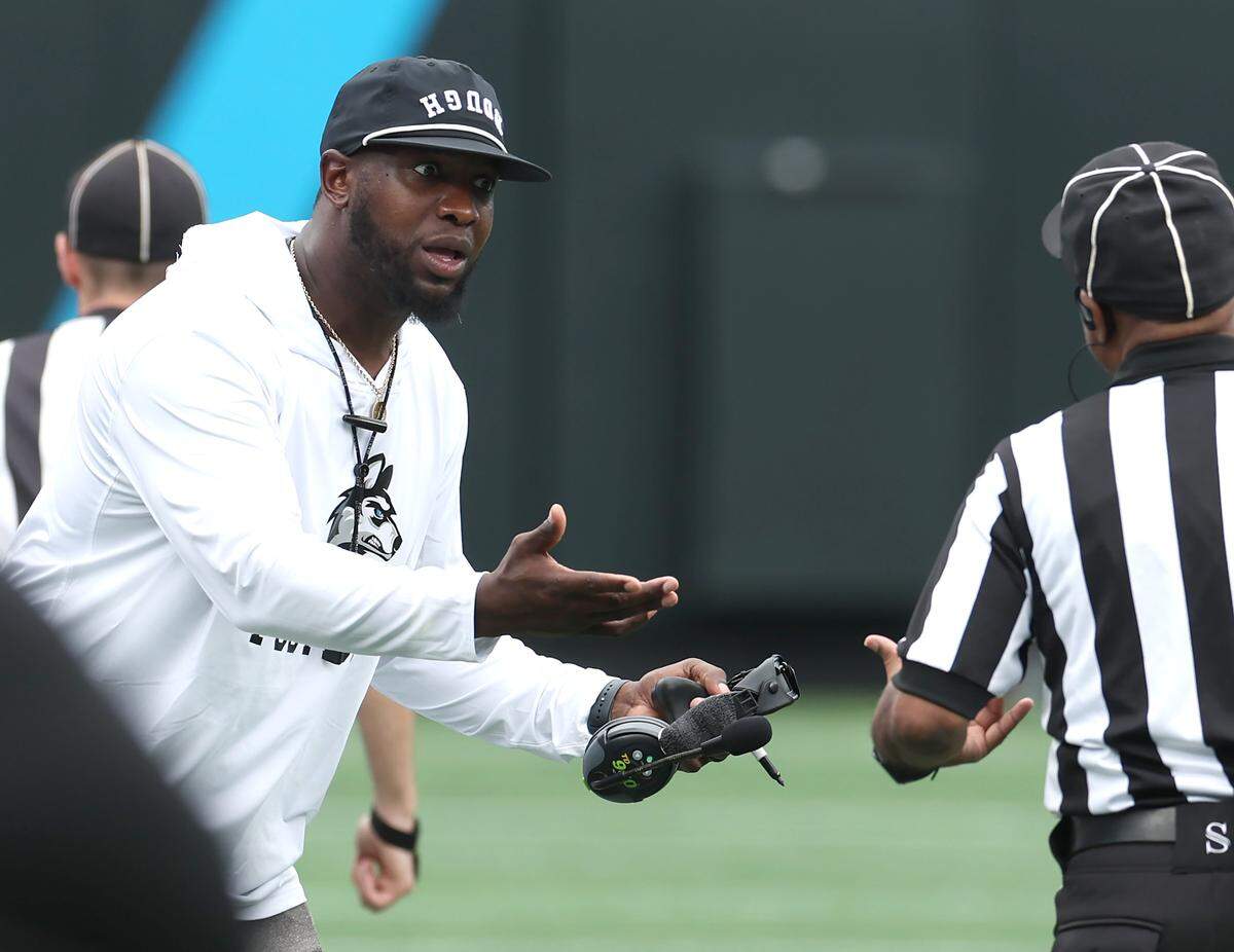 Hough Huskies head football coach DeShawn Baker stresses a point to an official during action against the South Pointe Stallions in the Keep Pounding Classic on Aug. 22, 2025 at Bank of America Stadium.