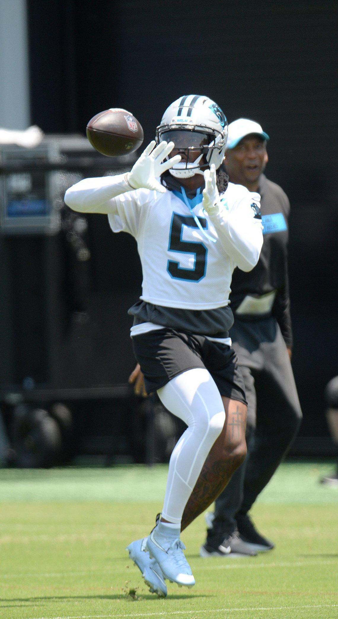 Rico Dowdle, #5, a Panthers running back, reels in a throw during practice. The Carolina Panthers, in their second week of organized team activities, ran through drills on Tuesday, June 3, 2025 at their practice facility in uptown Charlotte.