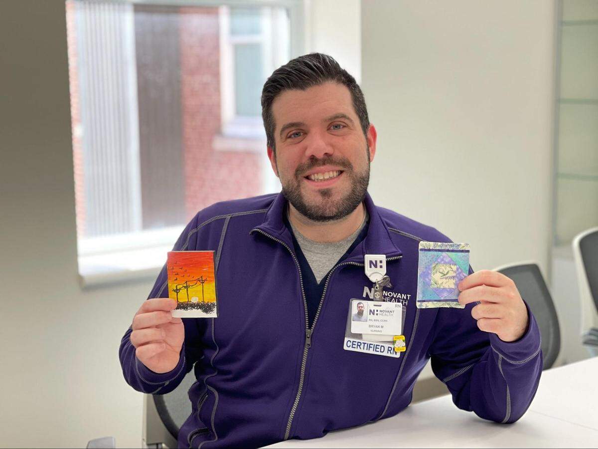 Assistant nursing assistant manager Bryan McLaughlin chose a painting that spoke to him and received the other in a Code Lavender gift bag.