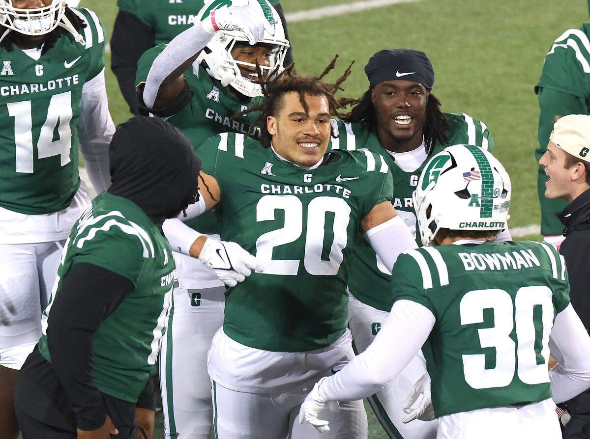 Charlotte 49ers defensive lineman Yamil Talib, center, celebrates his interception of a North Texas pass with his teammates during action on Friday, October 24, 2025 at Jerry Richardson Stadium.