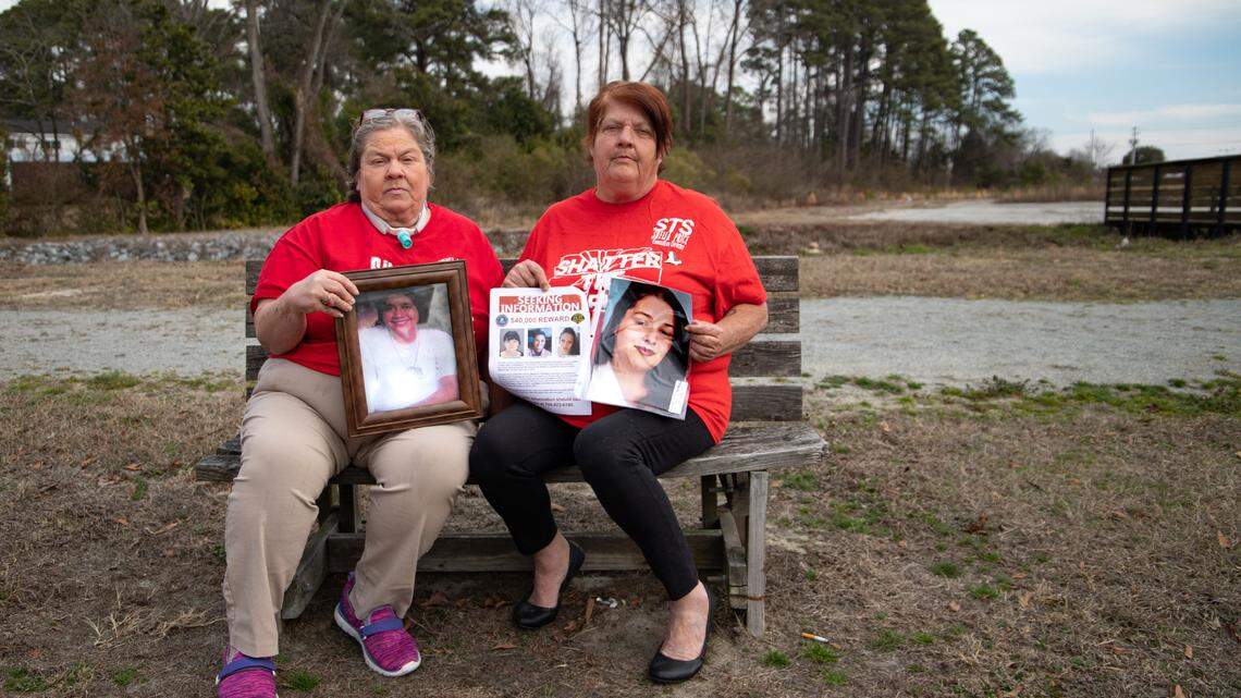 Angela Baxley (left) and Shelia Price (right) hold photos of their deceased relatives.