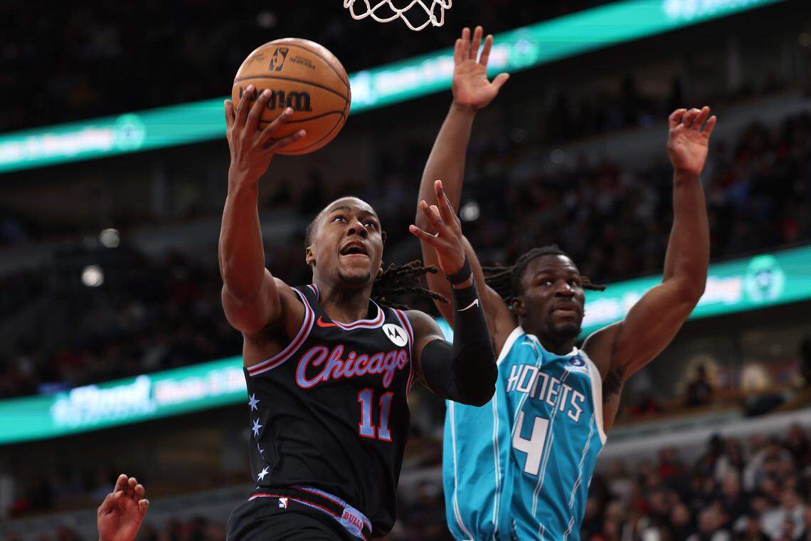 Chicago’s Ayo Dosunmu drives past Charlotte’s Sion James during Saturday’s first half at the United Center.