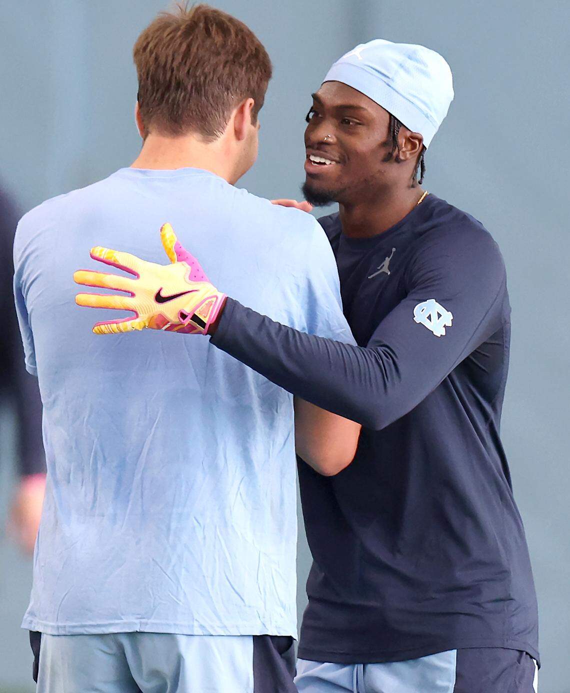 Wide receiver Tez Walker, right and quarterback Drake Maye, left, embrace after Walker caught a deep pass from Maye during the Carolina Football Pro Day at UNC Chapel Hill’s Koman Indoor Practice Facility on Thursday, March 28, 2024.